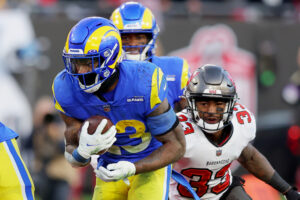 Cam Akers #23 of the Los Angeles Rams runs with the ball in the fourth quarter of the game against the Tampa Bay Buccaneers in the NFC Divisional Playoff game at Raymond James Stadium on January 23, 2022 in Tampa, Florida.