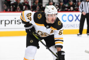 Brad Marchand #63 of the Boston Bruins gets ready during a face off against the Arizona Coyotes at Gila River Arena on January 28, 2022 in Glendale, Arizona.