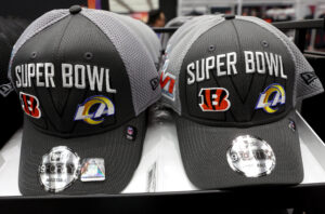 Super Bowl LVI hats are displayed for sale in the NFL Shop at the Los Angeles Convention Center on February 7, 2022 in Los Angeles, California. Super Bowl LVI will be played on February 13 at SoFi Stadium in Inglewood, California, where the hometown Los Angeles Rams will face the Cincinnati Bengals. 