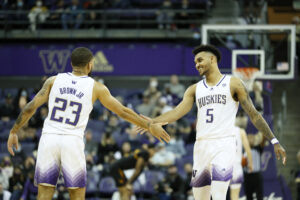 Terrell Brown Jr. #23 and Jamal Bey #5 of the Washington Huskies high five during the second half against the Arizona State Sun Devils at Alaska Airlines Arena on February 10, 2022 in Seattle, Washington. 