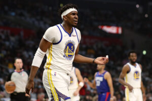 Kevon Looney #5 of the Golden State Warriors reacts to a play during the first quarter against the Los Angeles Clippers at Crypto.com Arena on February 14, 2022 in Los Angeles, California.