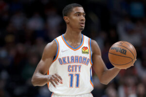 Theo Maledon #11of the Oklahoma City Thunder plays the Denver Nuggets at Ball Arena on March 02, 2022 in Denver, Colorado.