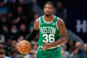 Marcus Smart #36 of the Boston Celtics brings the ball up court against the Charlotte Hornets during their game at Spectrum Center on March 09, 2022 in Charlotte, North Carolina.