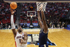 Bryson Williams #11 of the Texas Tech Red Raiders shoots over Great Osobor #3 of the Montana State Bobcats during the second half in the first round game of the 2022 NCAA Men's Basketball Tournament at Viejas Arena at San Diego State University