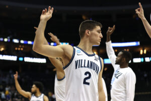 Collin Gillespie #2 of the Villanova Wildcats and teammates celebrate after defeating the Delaware Fightin Blue Hens 80-60 in the first round game of the 2022 NCAA Men's Basketball Tournament at PPG PAINTS Arena on March 18, 2022 in Pittsburgh, Pennsylvania