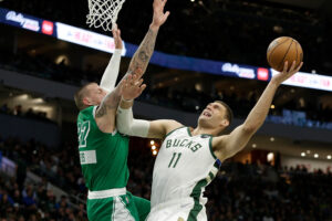 Brook Lopez (right) of the Milwaukee Bucks goes up for a shot during the second half against the Boston Celtics at Fiserv Forum on April 07, 2022 in Milwaukee, Wisconsin.