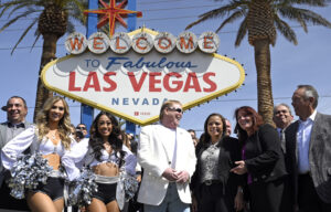 Las Vegas Raiders owner Mark Davis, center, speaks with Clark County officials at a kick-off event celebrating the 2022 NFL Draft at the Welcome To Fabulous Las Vegas sign on April 25, 2022 in Las Vegas, Nevada.