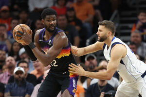 Deandre Ayton (left) of the Phoenix Suns handles the ball against Maxi Kleber (right) of the Dallas Mavericks during the first half of Game One of the Western Conference Second Round NBA Playoffs at Footprint Center on May 02, 2022 in Phoenix, Arizona. 