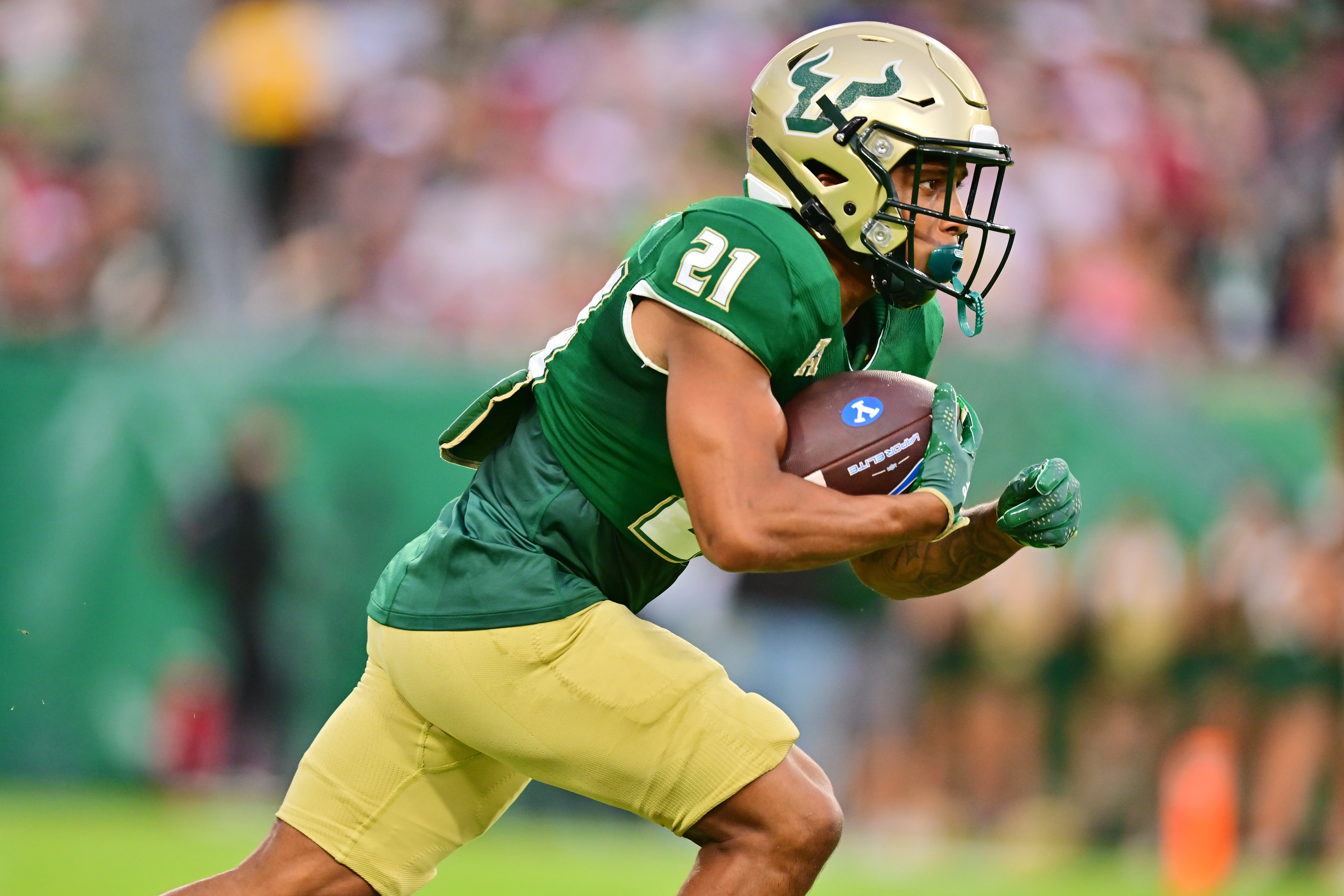 Brian Battie #21 of the South Florida Bulls runs for a 20-yard kickoff return in the first quarter against the Brigham Young Cougars at Raymond James Stadium on September 03, 2022 in Tampa, Florida.