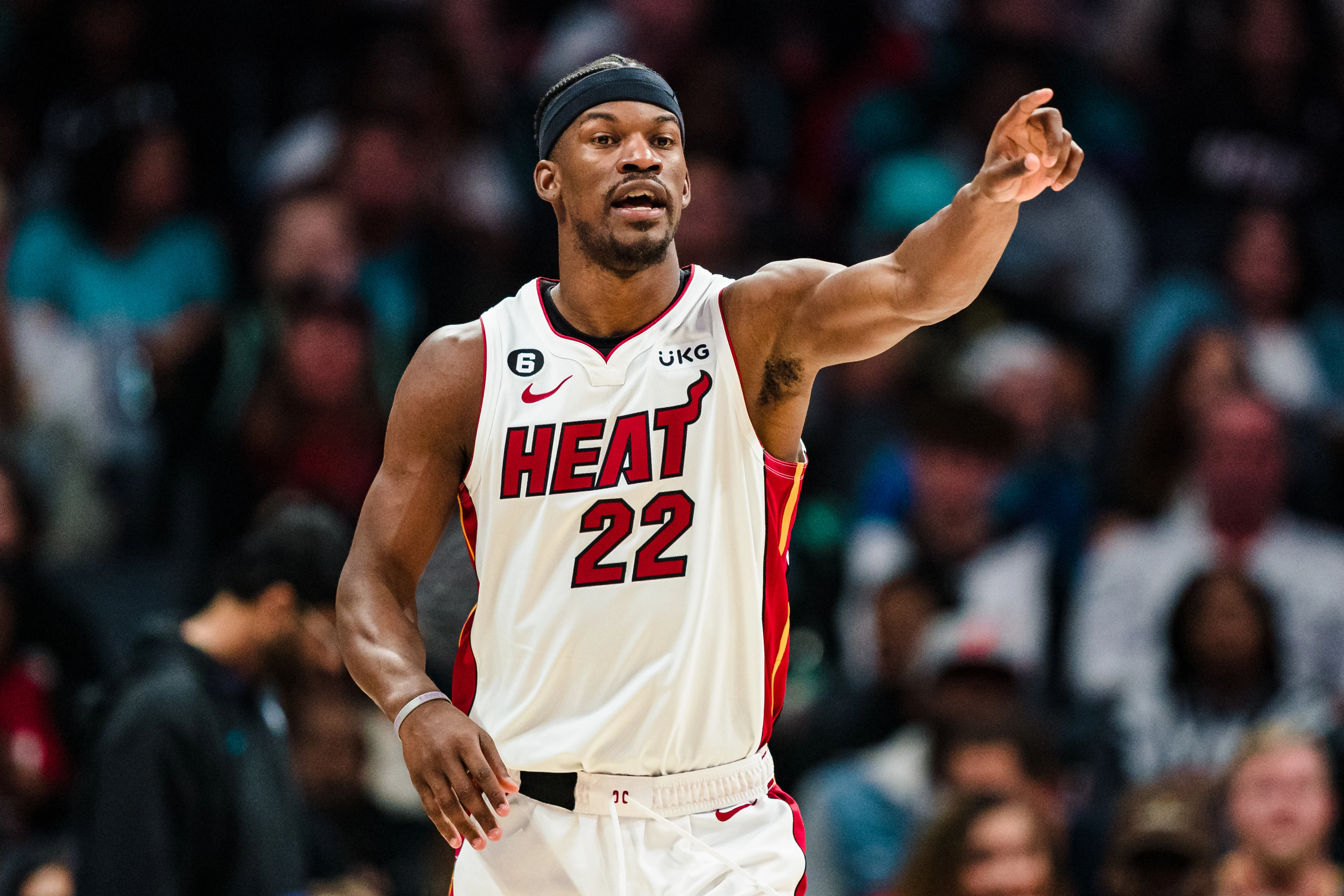 Jimmy Butler #22 of the Miami Heat directs a play against the Charlotte Hornets during their game at Spectrum Center on February 25, 2023 in Charlotte, North Carolina.
