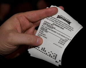 A bettor displays a betting ticket after placing wagers on some of the more than 400 proposition bets for Super Bowl LI between the Atlanta Falcons and the New England Patriots at the SuperBook at the Westgate Las Vegas 