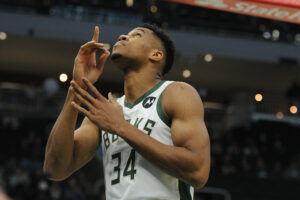 Milwaukee Bucks forward Giannis Antetokounmpo points to the sky before the start of a game