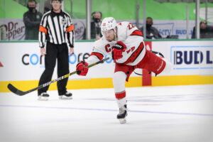 Carolina Hurricanes defenseman Brett Pesce takes a shot in an NHL game against the Dallas Stars