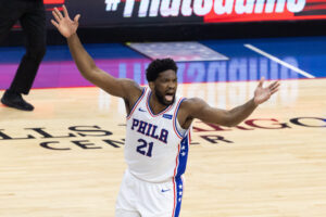 Philadelphia 76ers center Joel Embiid waves his arms after scoring