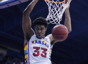 David McCormack #33 of the Kansas Jayhawks dunks against the Kansas State Wildcats in the first half at Allen Fieldhouse on February 22, 2022 in Lawrence, Kansas.