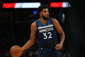 Minnesota Timberwolves center Karl-Anthony Towns dribbles the ball with his right hand