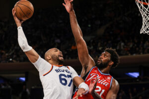 New York Knicks center Taj Gibson (left) shoots the ball as Philadelphia 76ers center Joel Embiid (right) defends during a game at Madison Square Garden.