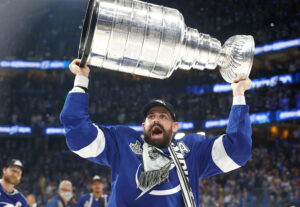 Tampa Bay Lightning left wing Alex Killorn lifts the Stanley Cup over his head in celebration