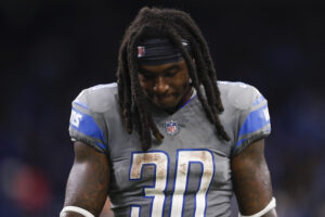 Detroit Lions running back Jamal Williams walks off the field dejected with his head down after a loss