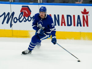 Toronto Maple Leafs forward Auston Matthews skating on the ice with the puck on his stick