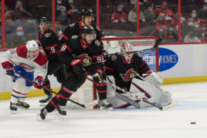 Ottawa Senators defenseman Victor Mete skates with the puck in front of his own net