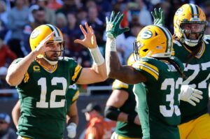 Green Packers quarterback Aaron Rodgers on the left celebrates with running back Aaron Jones after scoring a touchdown