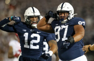 Two unidentified Penn State defensive football players flexing after making a big play