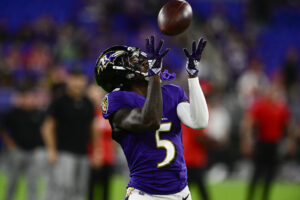 Baltimore Ravens wide receiver Marquise Brown raises his hands to catch a football 