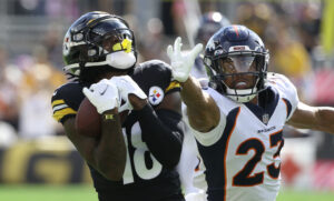 Pittsburgh Steelers wide receiver Diontae Johnson makes a catch while being defended by Denver Broncos cornerback Kyle Fuller