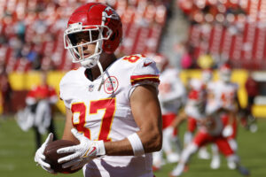 Kansas City Chiefs tight end Travis Kelce holds a football while on the field during pregame warmups