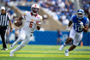 Louisiana Monroe Warhawks quarterback Hayes Crockett carries the ball with Kentucky Wildcats linebacker Jacquez Jones following behind