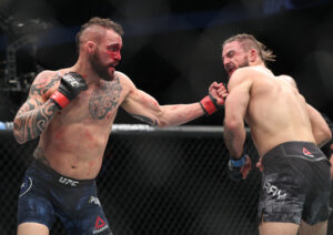 Santiago Ponzinibbio (left) throws a left uppercut at opponent Mike Perry during UFC Fight Night