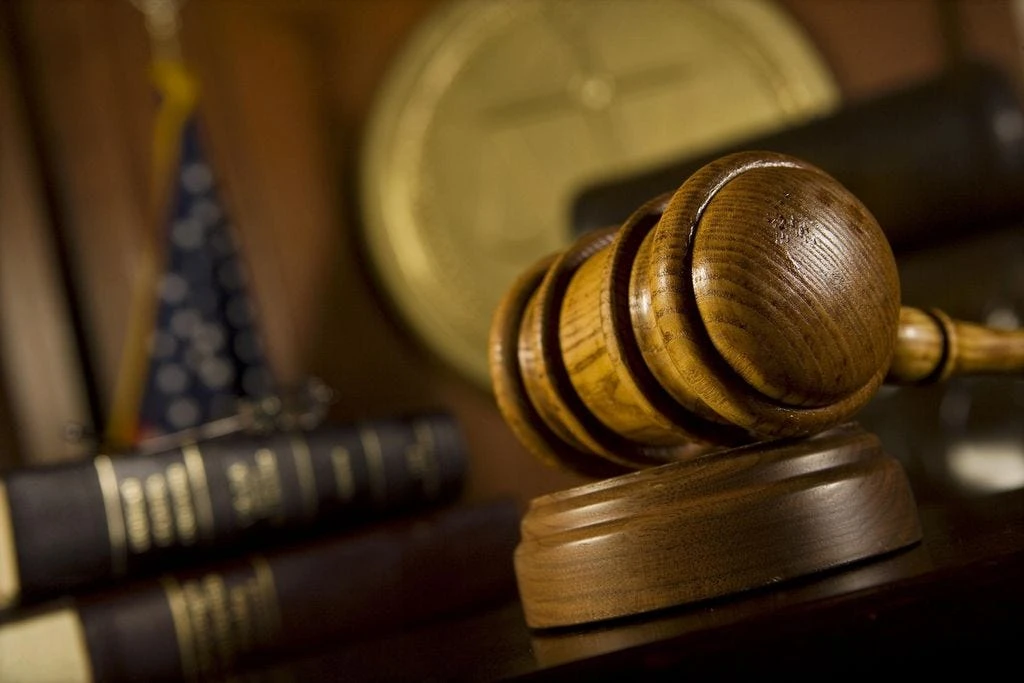A gavel rests on a judge's bench.