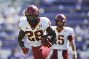 Iowa State running back Breece Hall runs with the football in his left hand during a game in 2021