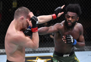 Aljamain Sterling (right) connects with a straight right hand to the chin of Petr Yan (left) in their UFC bantamweight championship fight during UFC 259