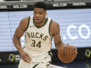 Milwaukee Bucks forward #34 Giannis Antetonkoumpo brings the ball up the court in a 2020 home game.