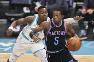 Sacramento Kings guard De'Aaron Fox makes a move past Terry Rozier of the Hornets in a 2021 game.