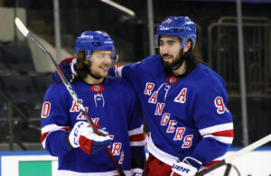 Artemi Panarin #10 and Mika Zibanejad #93 of the New York Rangers celebrate their 8-4 victory over the Pittsburgh Penguins at Madison Square Garden on April 06, 2021 in New York City. 