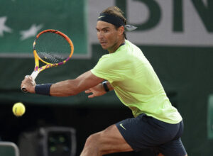 Rafael Nadal goes to his backhand to return a shot during his semifinal match against Novak Djokovic at the 2021 French Open