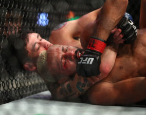 Jun 12, 2021; Glendale, Arizona, USA; Brandon Moreno applies a choke hold for the victory against Deiveson Figueiredo during UFC 263 at Gila River Arena.