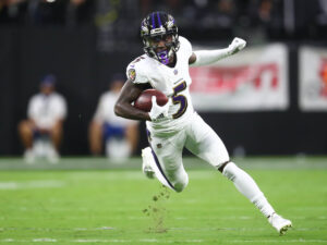 Baltimore Ravens wide receiver Marquise Brown (5) runs the ball against the Las Vegas Raiders during the first half at Allegiant Stadium. 