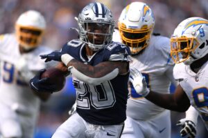 Dallas Cowboys running back Tony Pollard (20) runs the ball against Los Angeles Chargers linebacker Kenneth Murray (9) during the second half at SoFi Stadium.