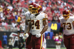 Washington Football Team running back Antonio Gibson (24) celebrates after a touchdown against the Atlanta Falcons in the second quarter at Mercedes-Benz Stadium.