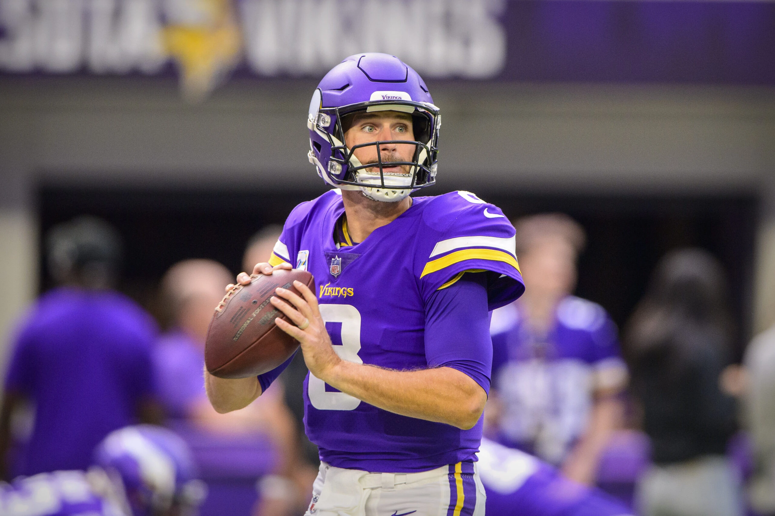 Minnesota Vikings quarterback #8 Kirk Cousins looks for an open receiver in a 2021 home game.