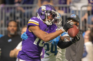 Minnesota Vikings wide receiver Justin Jefferson catches a pass for a first down as Detroit Lions cornerback Amani Oruwariye defends