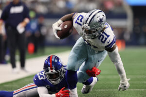 Dallas Cowboys running back Ezekiel Elliott carries the ball as New York Giants safety Logan Ryan defends