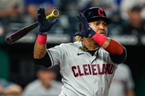 Cleveland Indians third baseman Jose Ramirez lets go of his bat with both hands after making contact on a ball against the Kansas City Royals