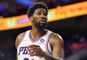 Philadelphia Sixers center #21 Joel Embiid reacts to a foul call in a 2021 home game.