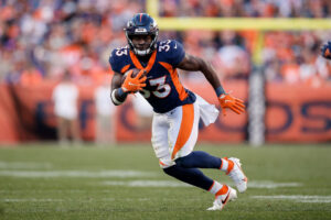 Denver Broncos running back Javonte Williams (33) runs the ball in the fourth quarter against the Las Vegas Raiders at Empower Field at Mile High. 