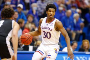 Kansas guard Ochai Agbaji looks to pass the basketball during a game against Emporia State